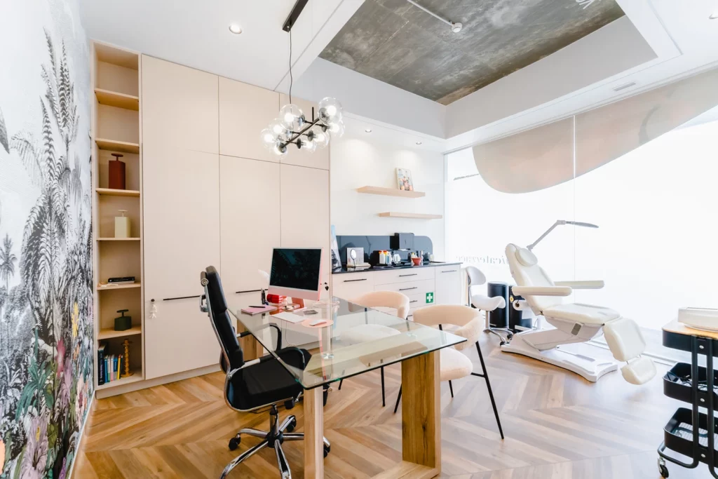 a room with a desk and chairs